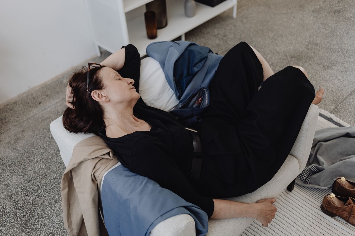 Woman resting with her eyes closed on a chair