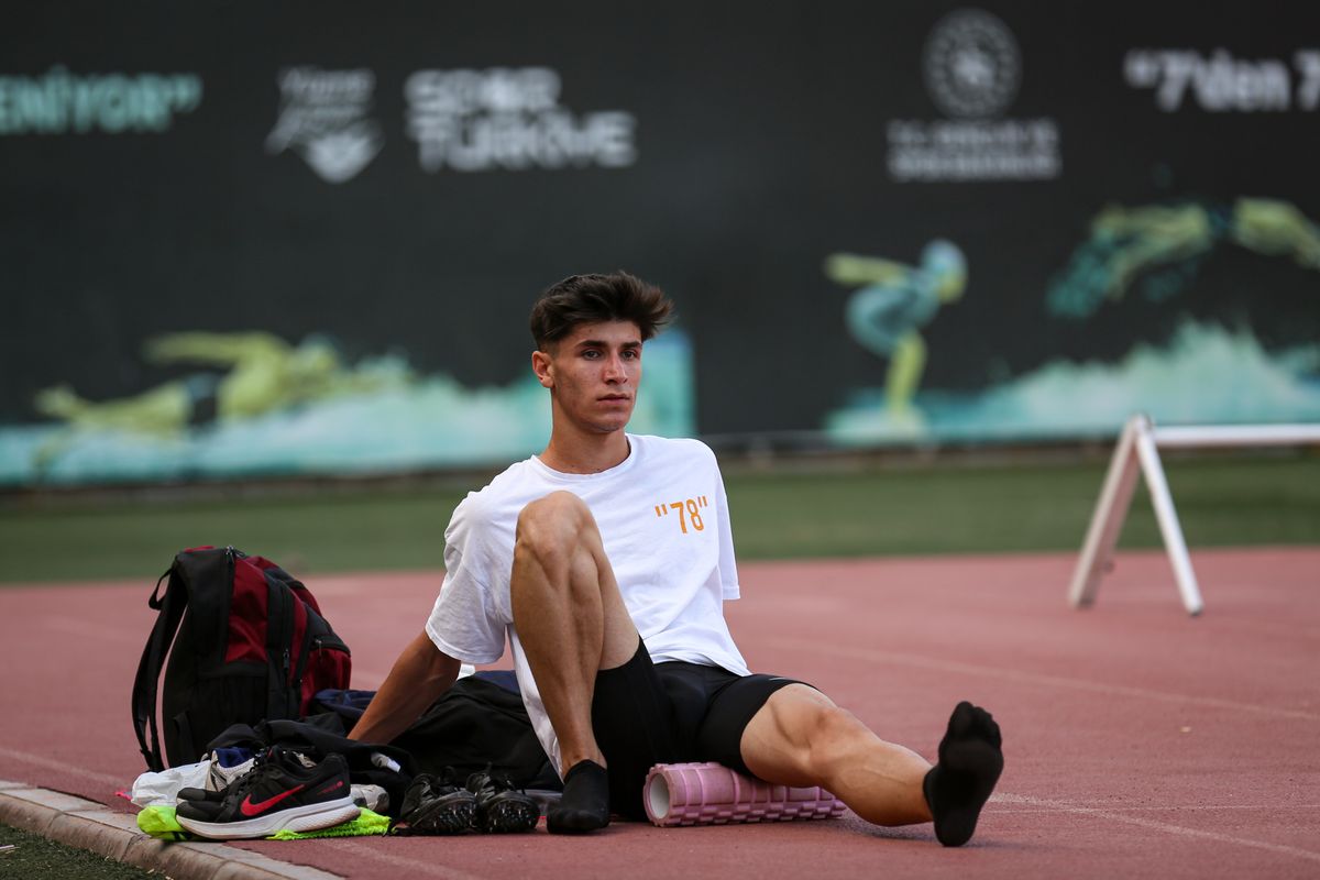 Athlete using a foam roller to massage their leg after training