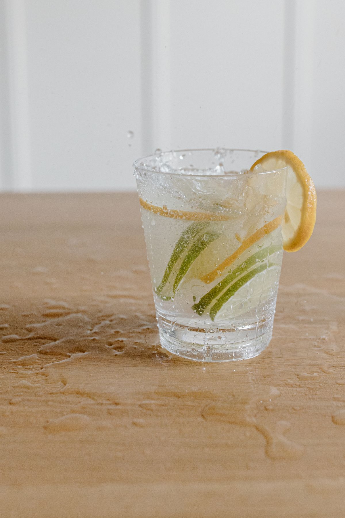 Glass of water with lemon and lime slices