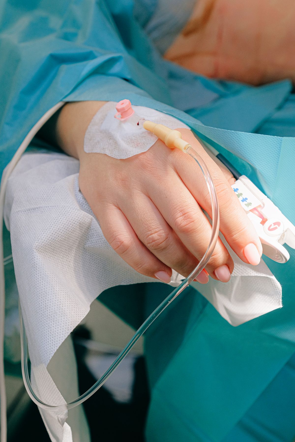 Close-up of a patient's hand with an IV line connected