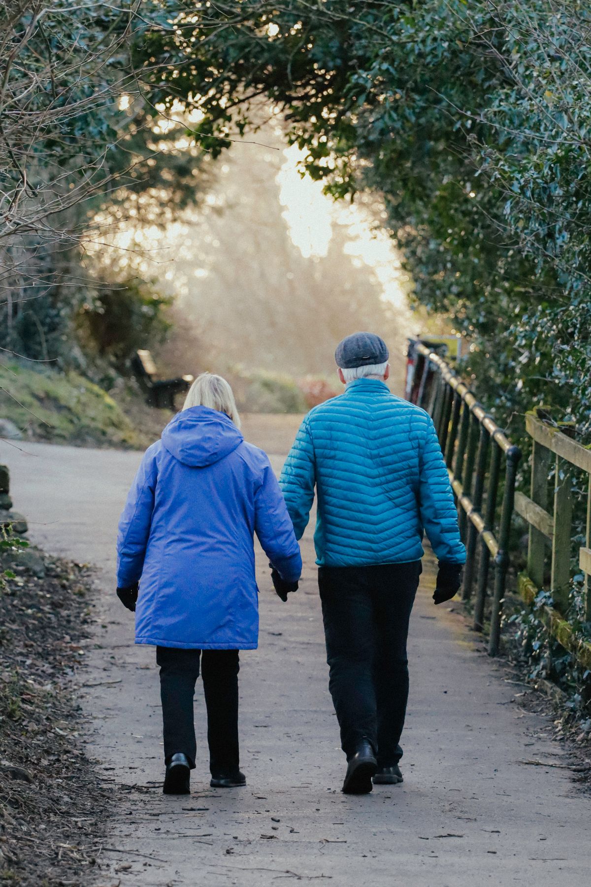 Older couple walking together along a park path