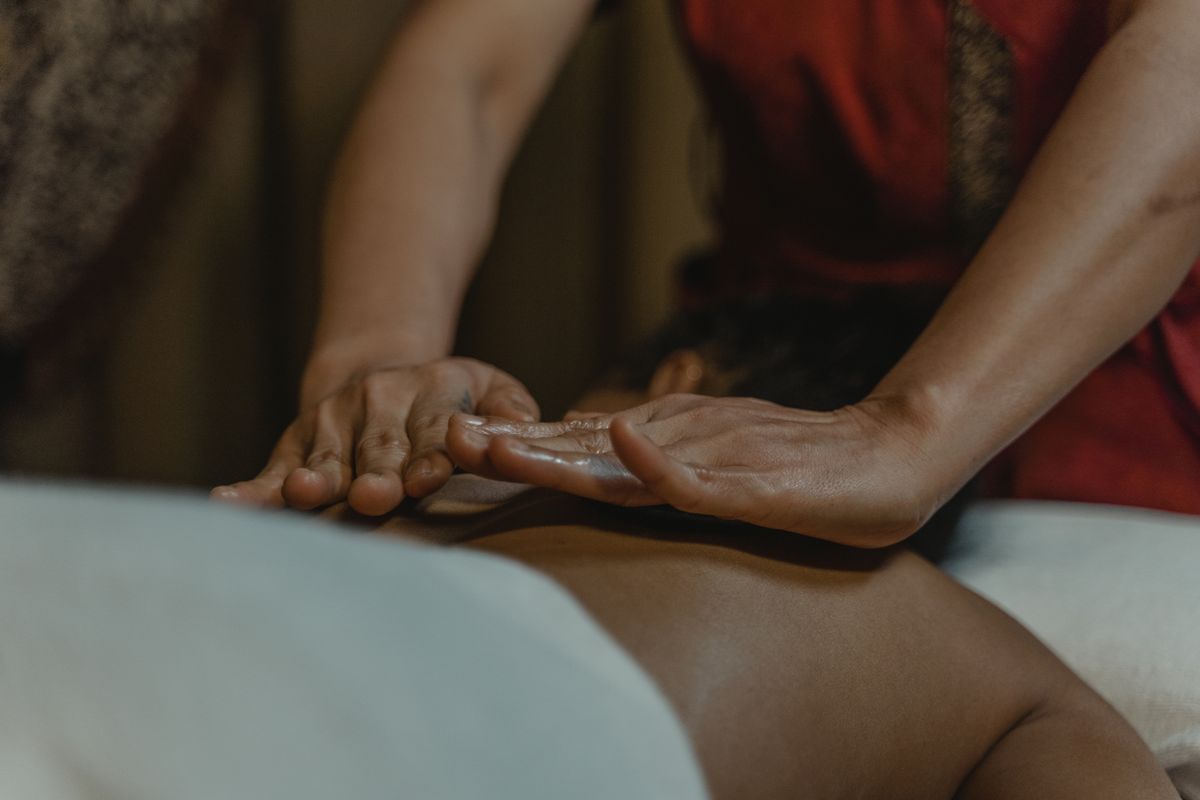 Therapist's hands performing a back massage