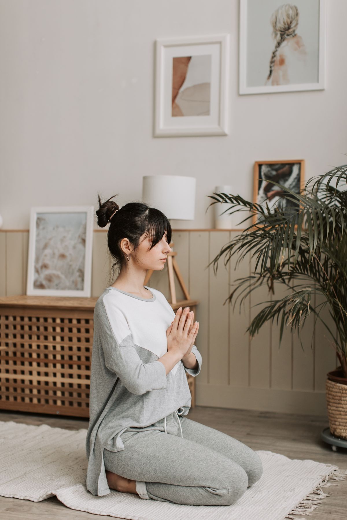 Woman meditating calmly at home