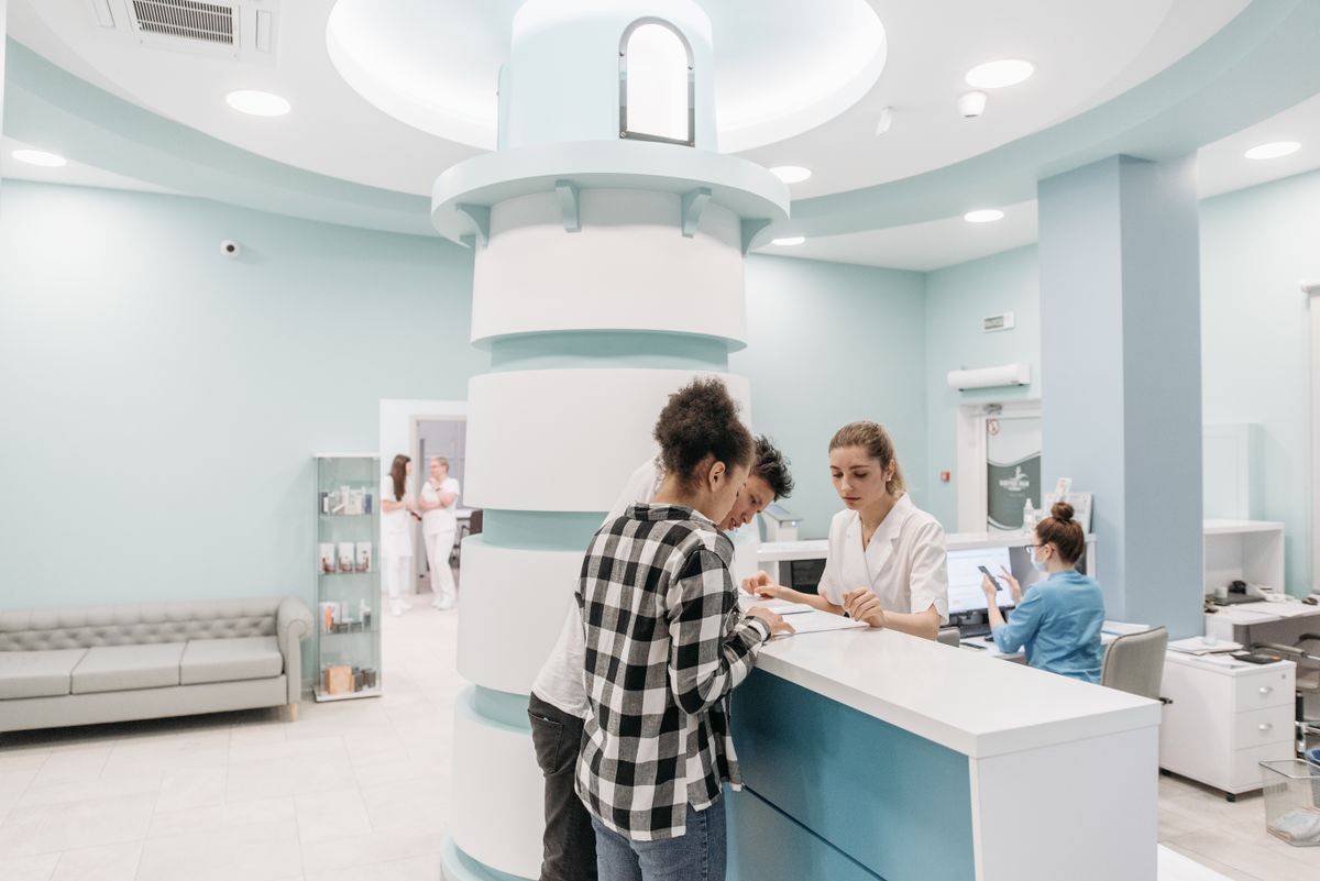 Patient checking in at a clinic reception desk