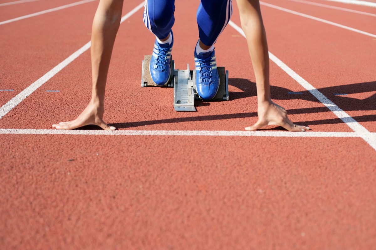 Runner in starting position on a track