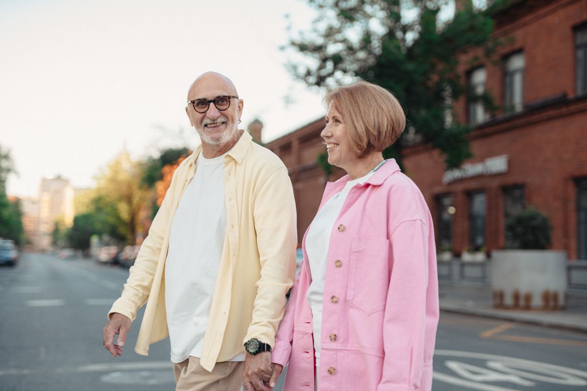 Happy couple holding hands while walking outdoors